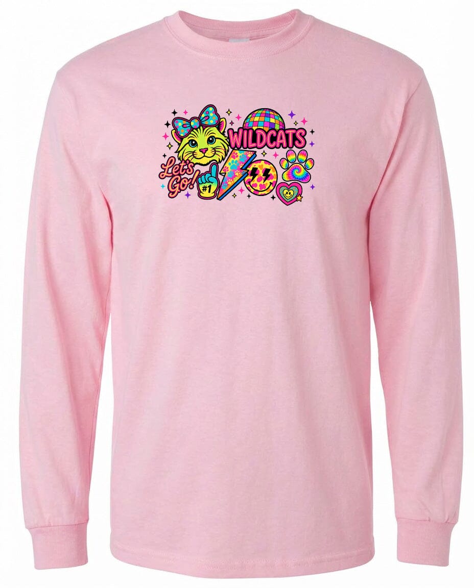 A pink long-sleeved t-shirt with a colorful graphic design featuring a cat, a rainbow, and the text "Wildcats" along with a smiley face.