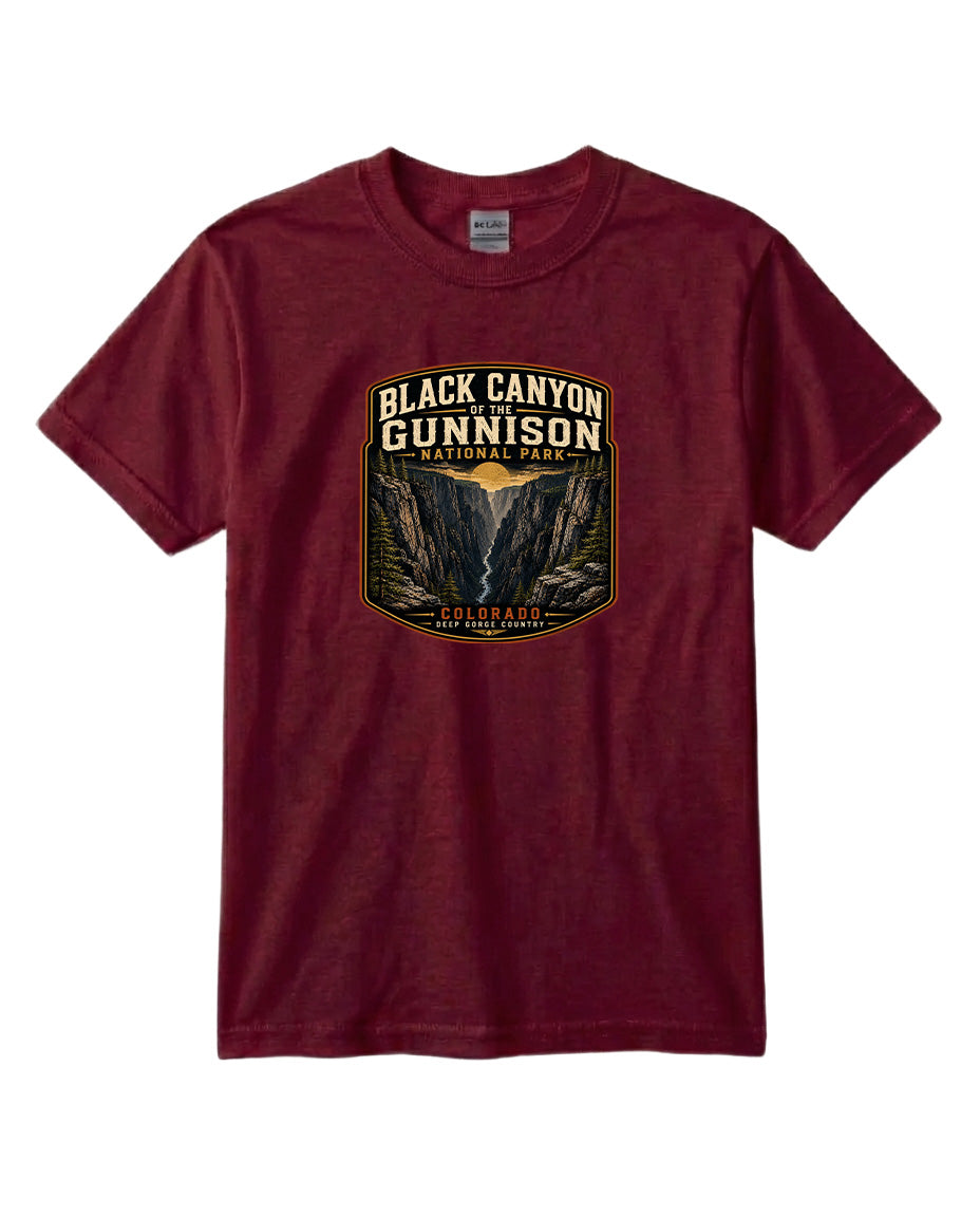A burgundy-colored t-shirt with a graphic design depicting the Black Canyon of the Gunnison National Park.