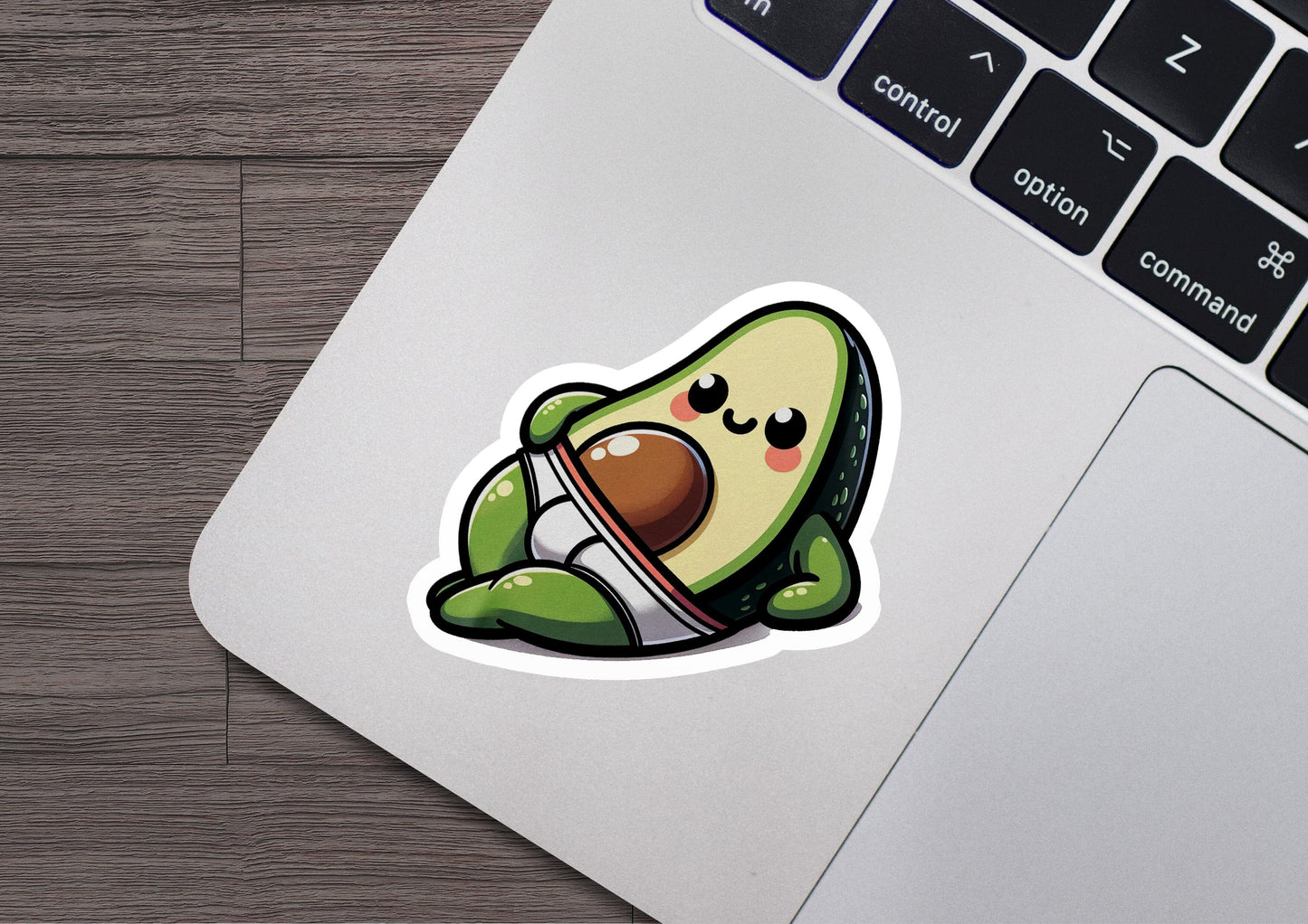 an avocado sticker sitting on top of a laptop