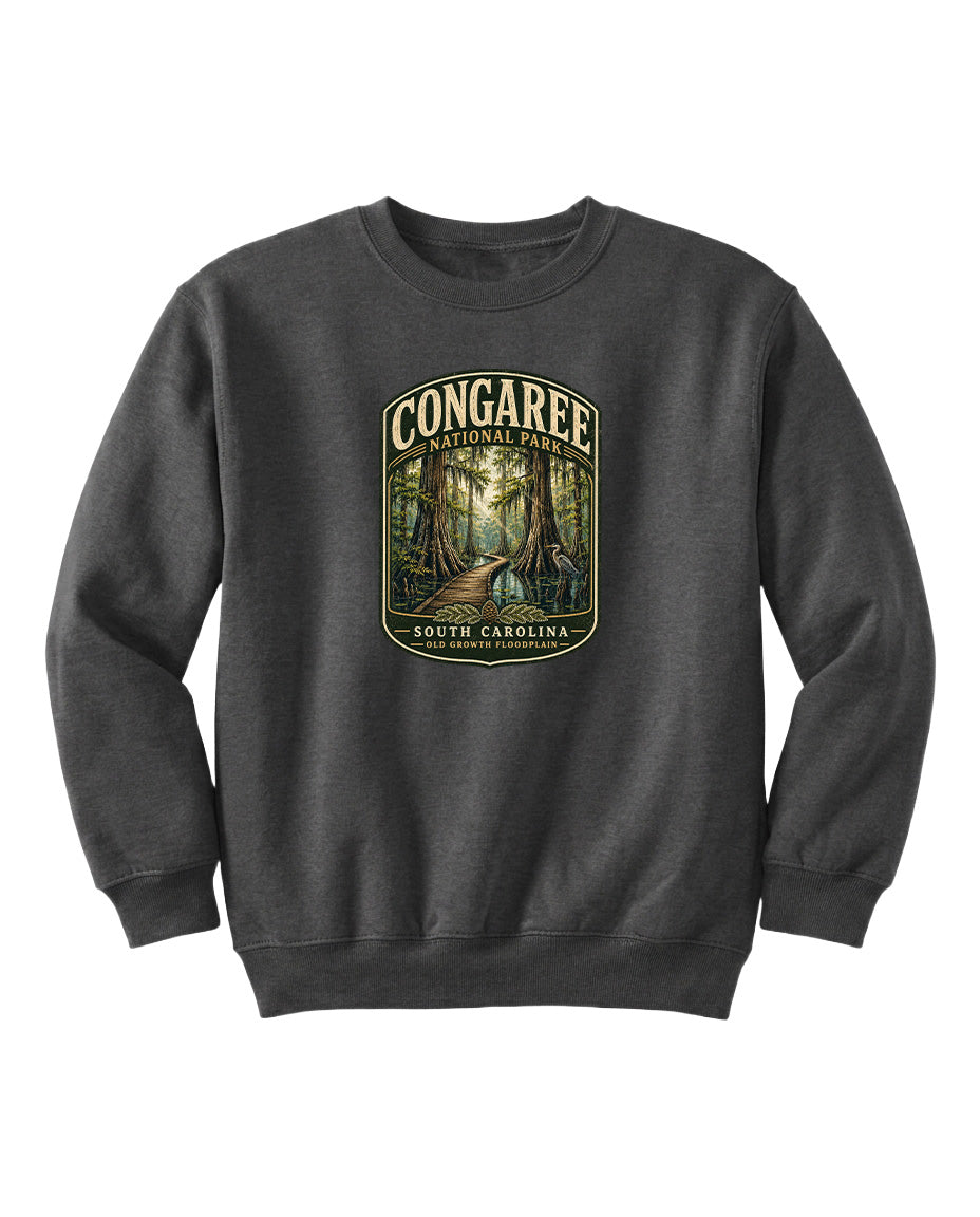 A gray sweatshirt with a graphic design depicting a forest scene, featuring the text "CONGAREE NATIONAL PARK SOUTH CAROLINA" prominently displayed.