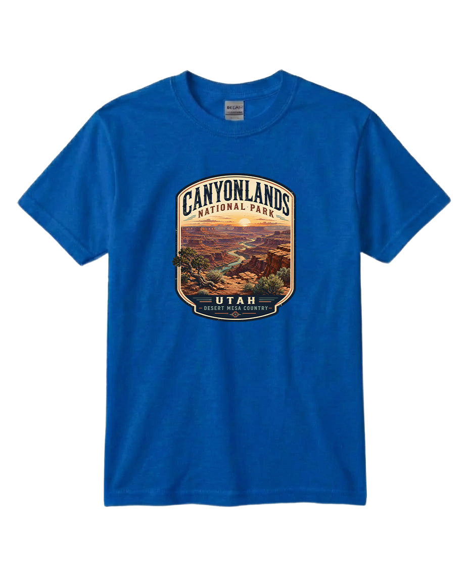 A blue t-shirt with a graphic design depicting a scenic landscape, including mountains, a river, and a desert landscape.