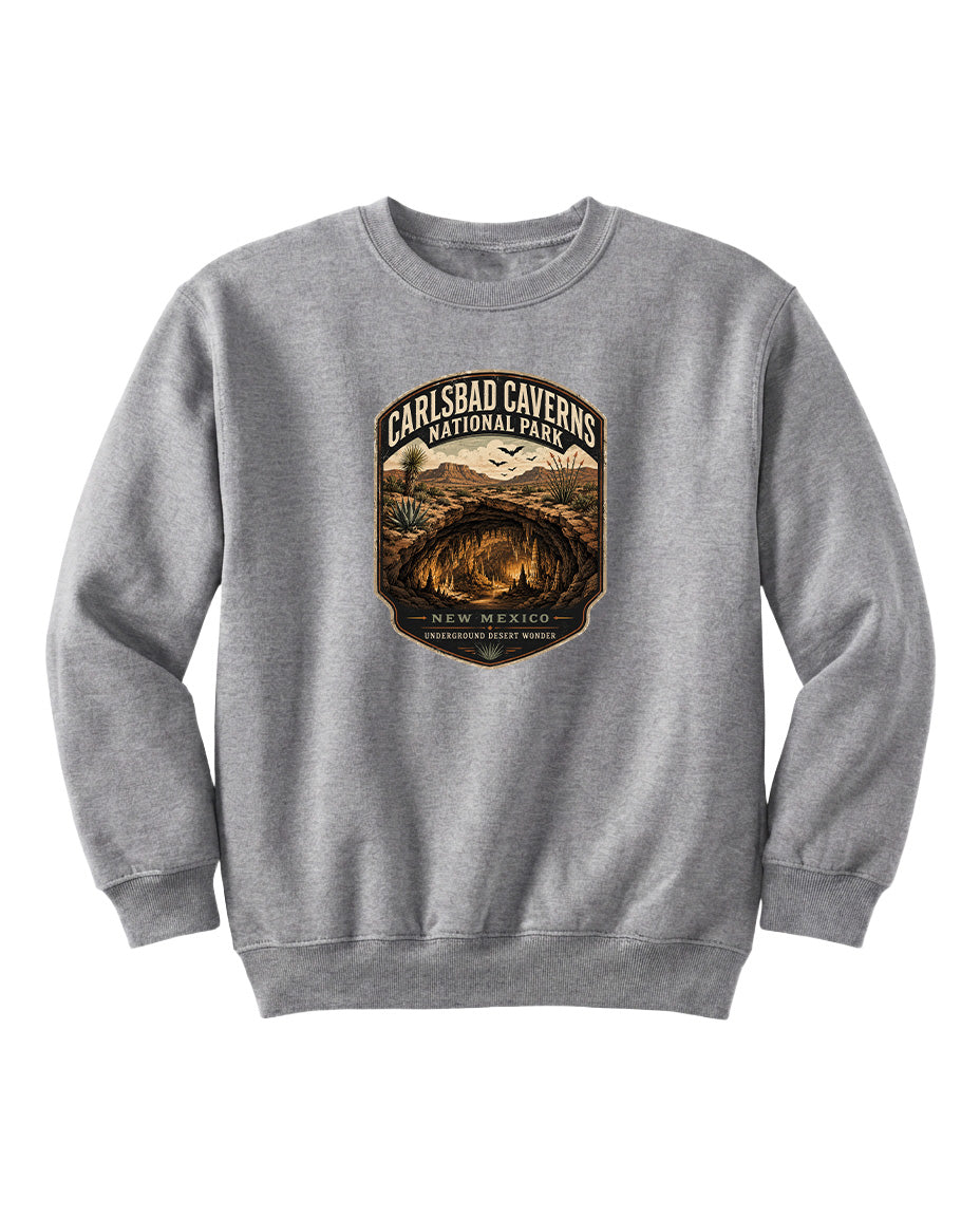 A gray sweatshirt with a graphic design featuring a shield-shaped emblem with text and an illustration of a desert landscape.