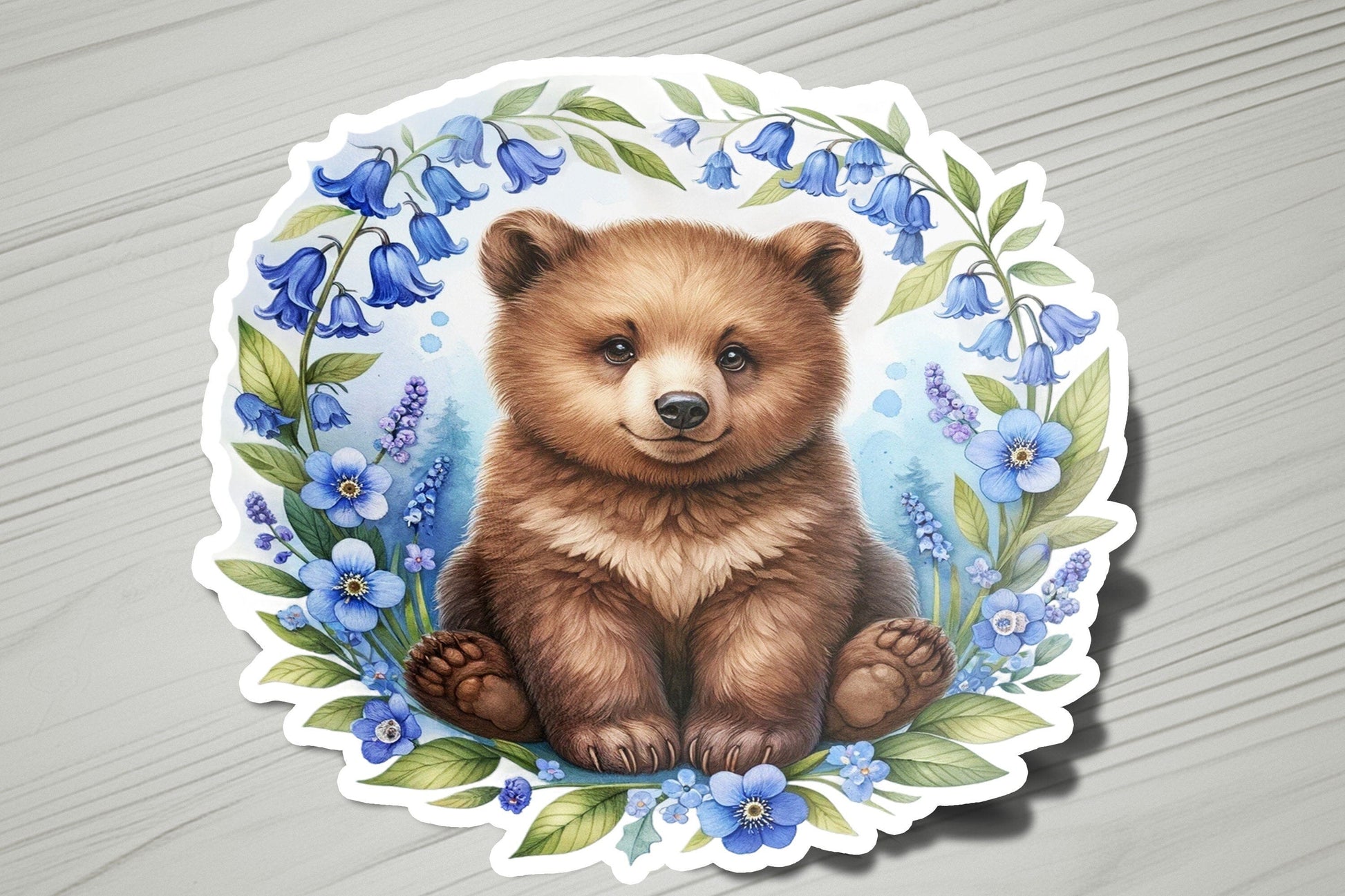 a sticker of a brown bear surrounded by blue flowers