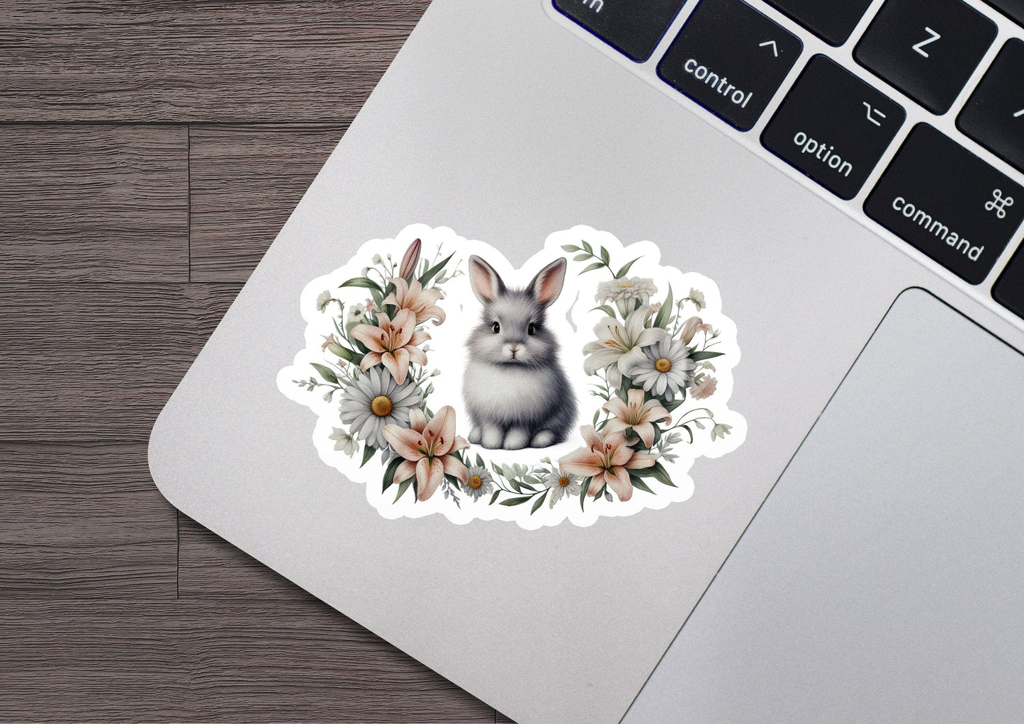 a laptop with a sticker of a rabbit and flowers