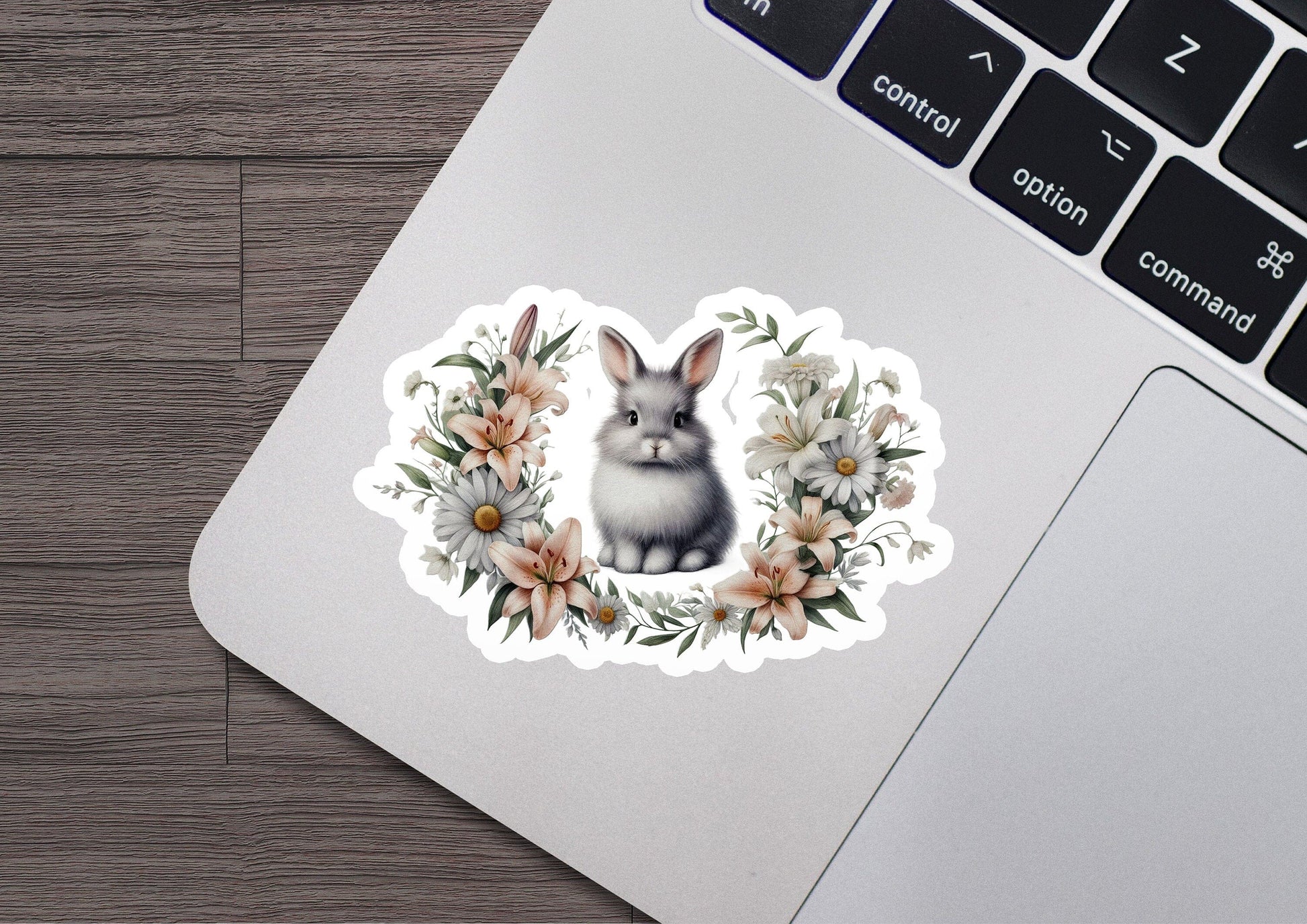 a laptop with a sticker of a rabbit and flowers