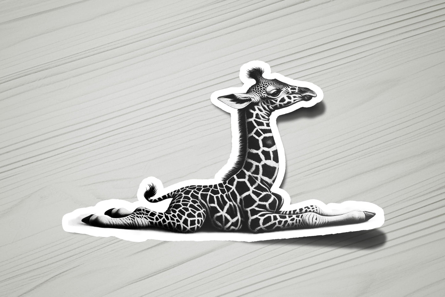 a sticker of a giraffe laying on the ground