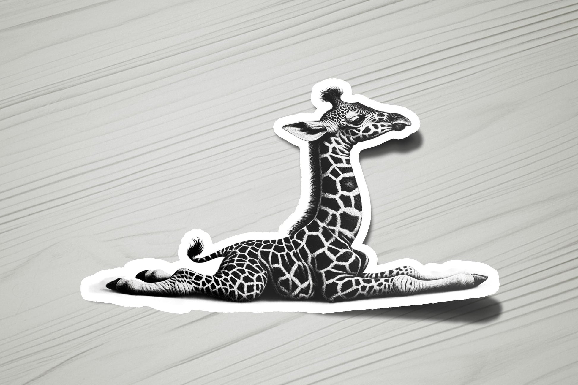 a sticker of a giraffe laying on the ground