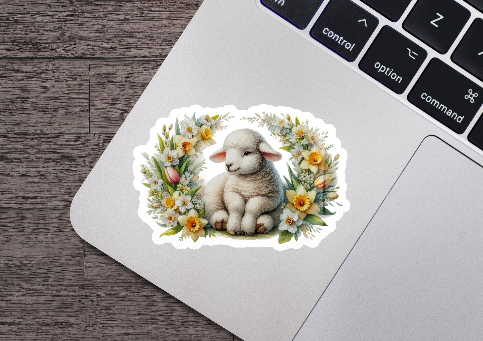 a sticker of a sheep sitting on a laptop keyboard