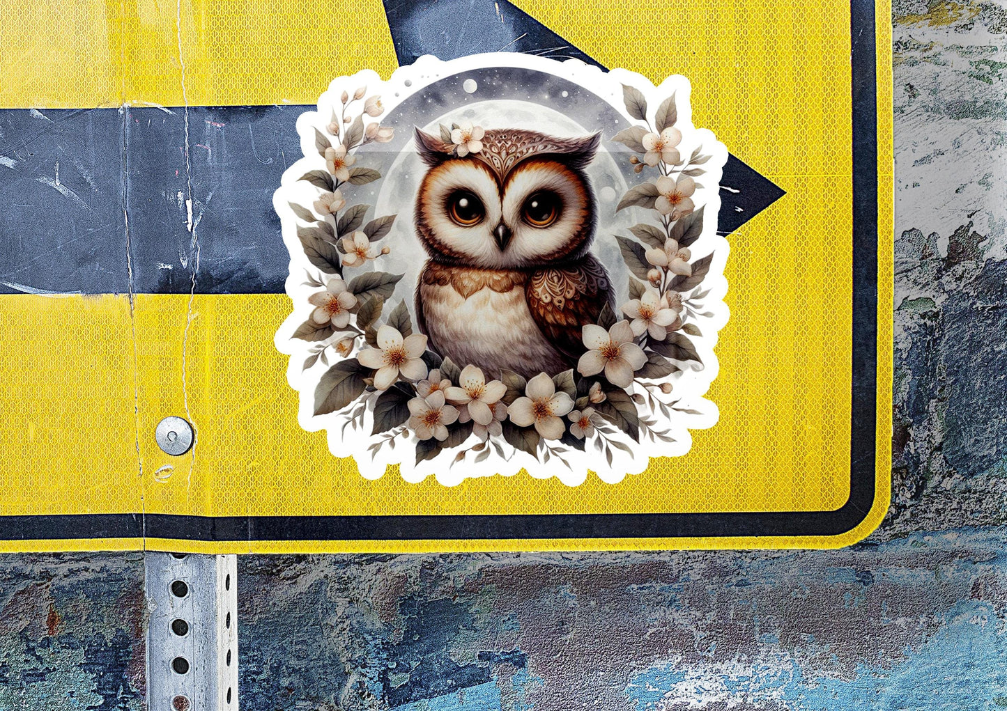 a sticker of an owl on a street sign