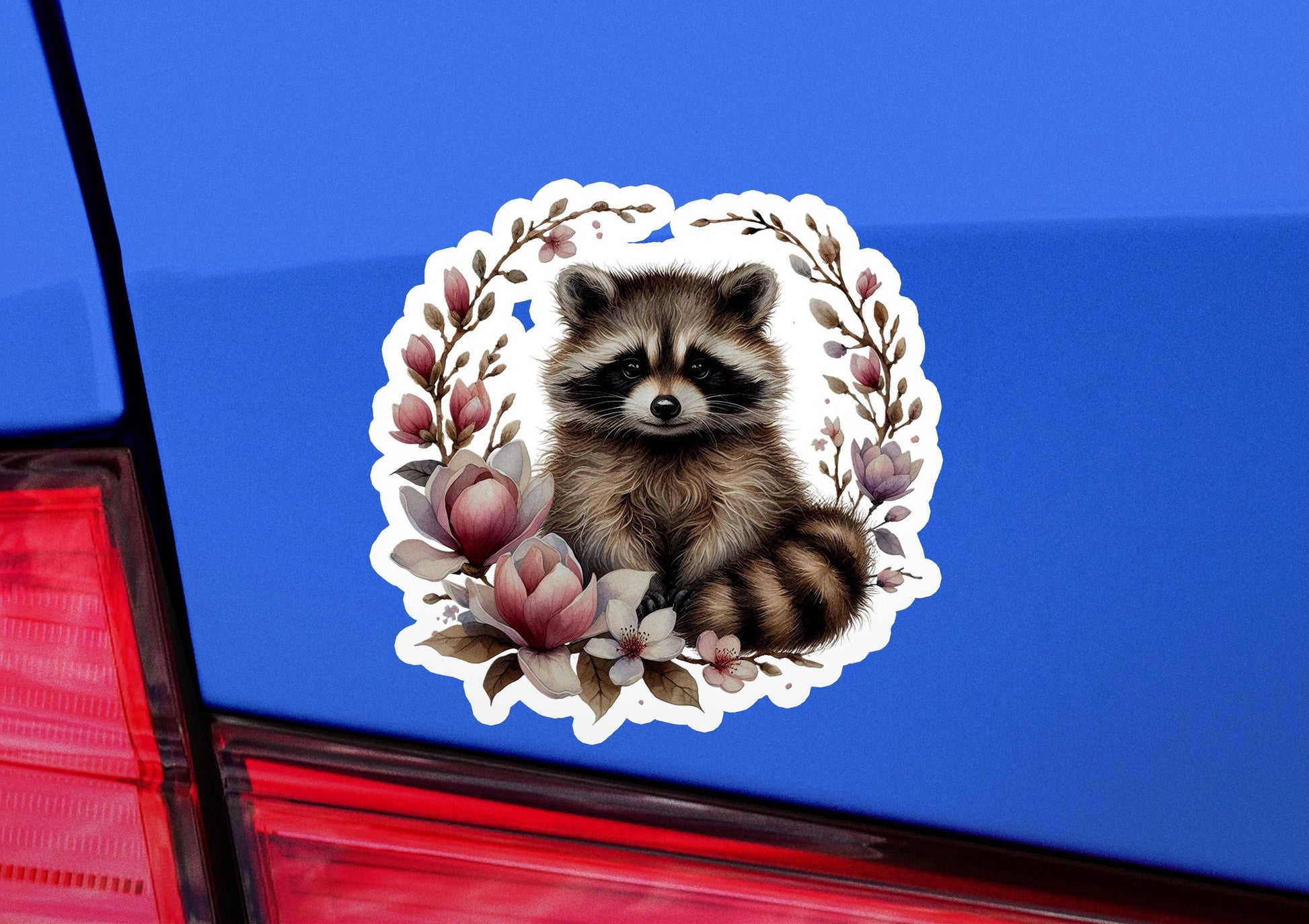 a sticker of a raccoon sitting on the back of a car