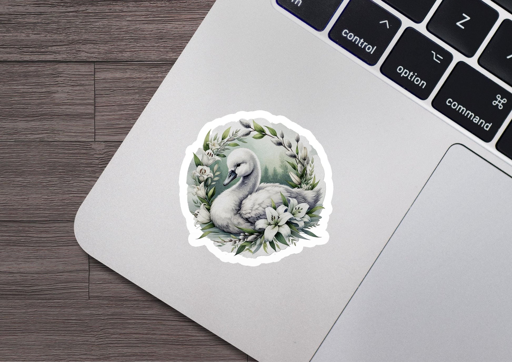a laptop with a sticker of a bird and flowers on it