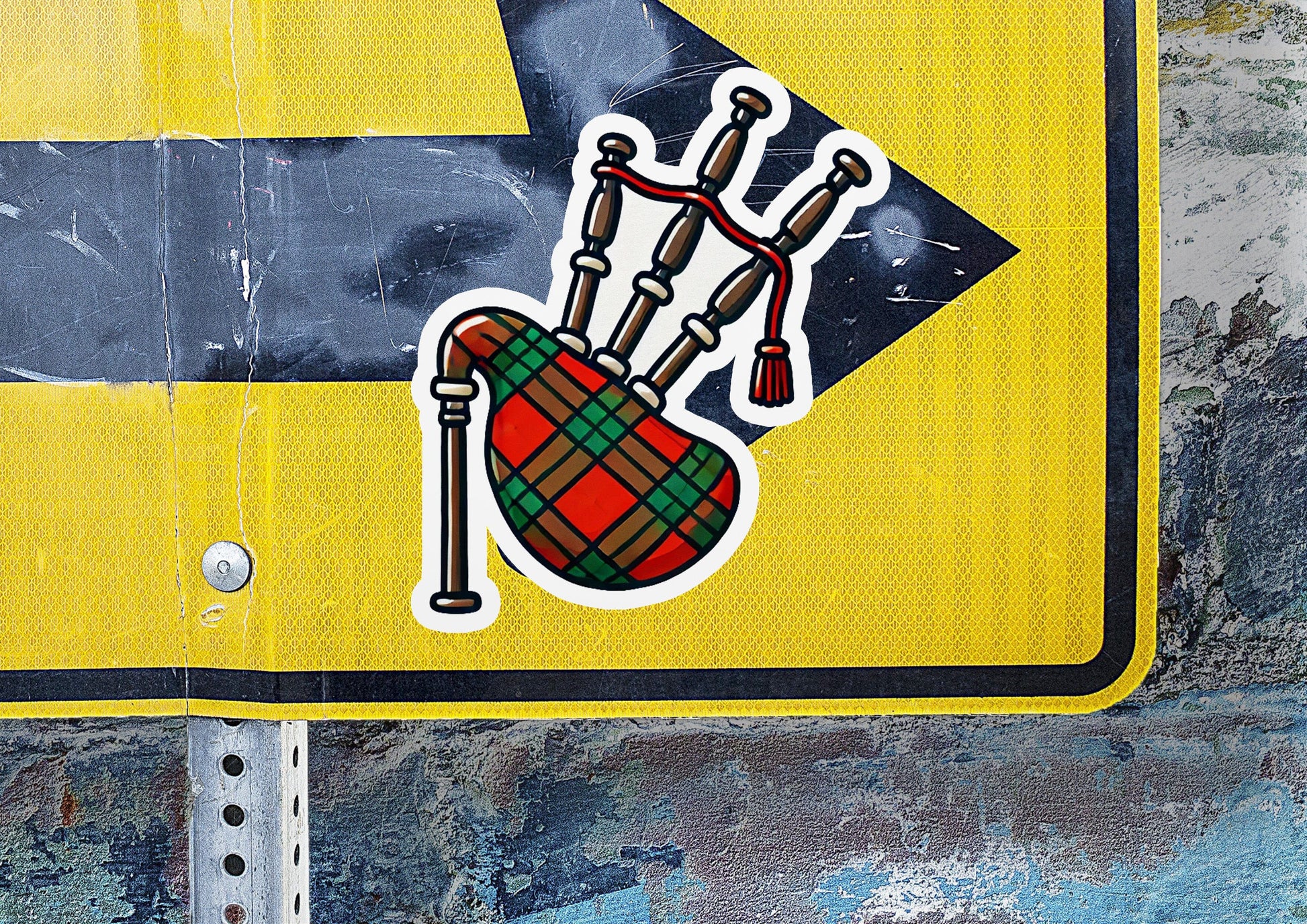 a yellow street sign with stickers on it