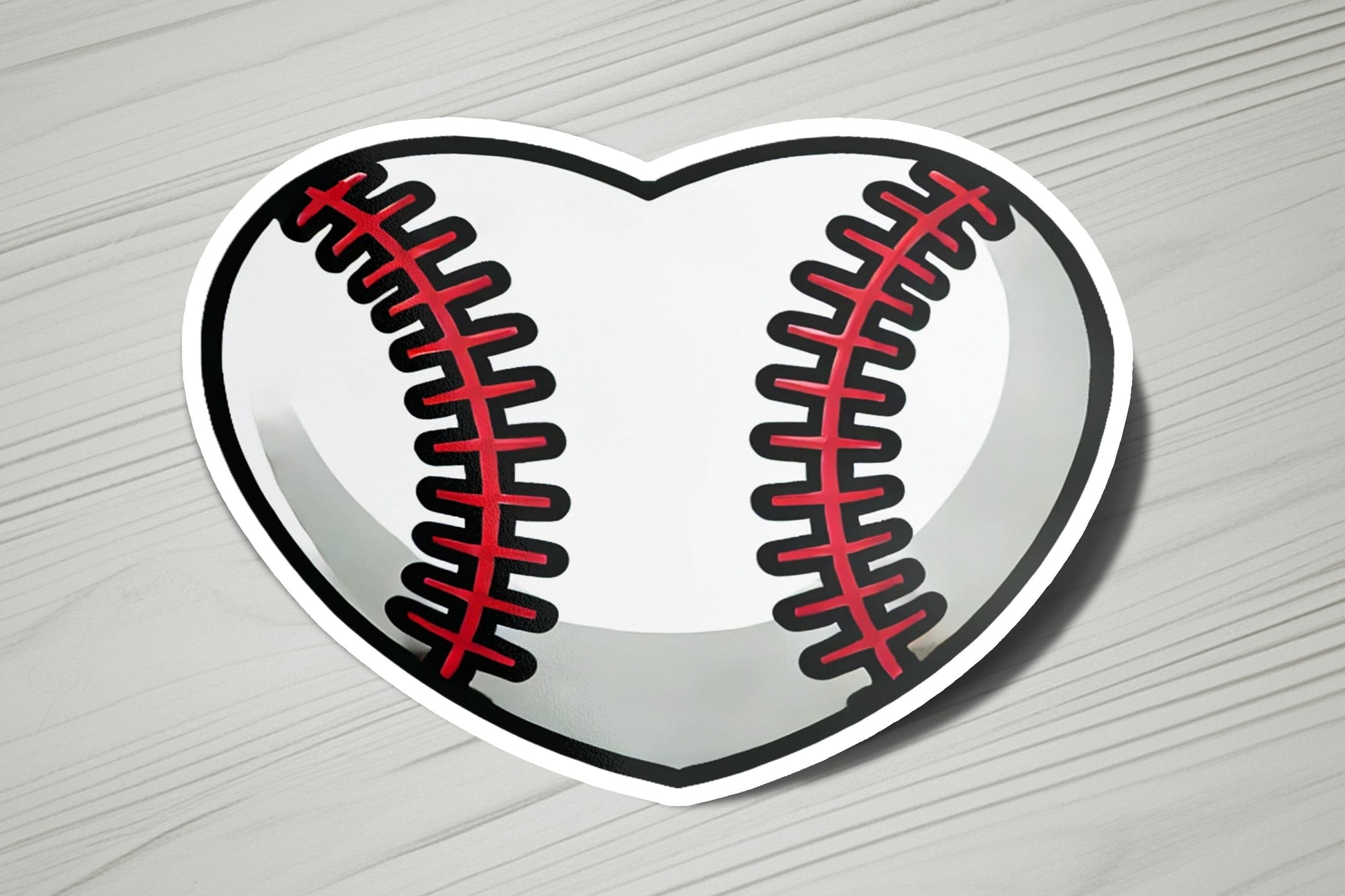 a heart shaped sticker with a baseball on it