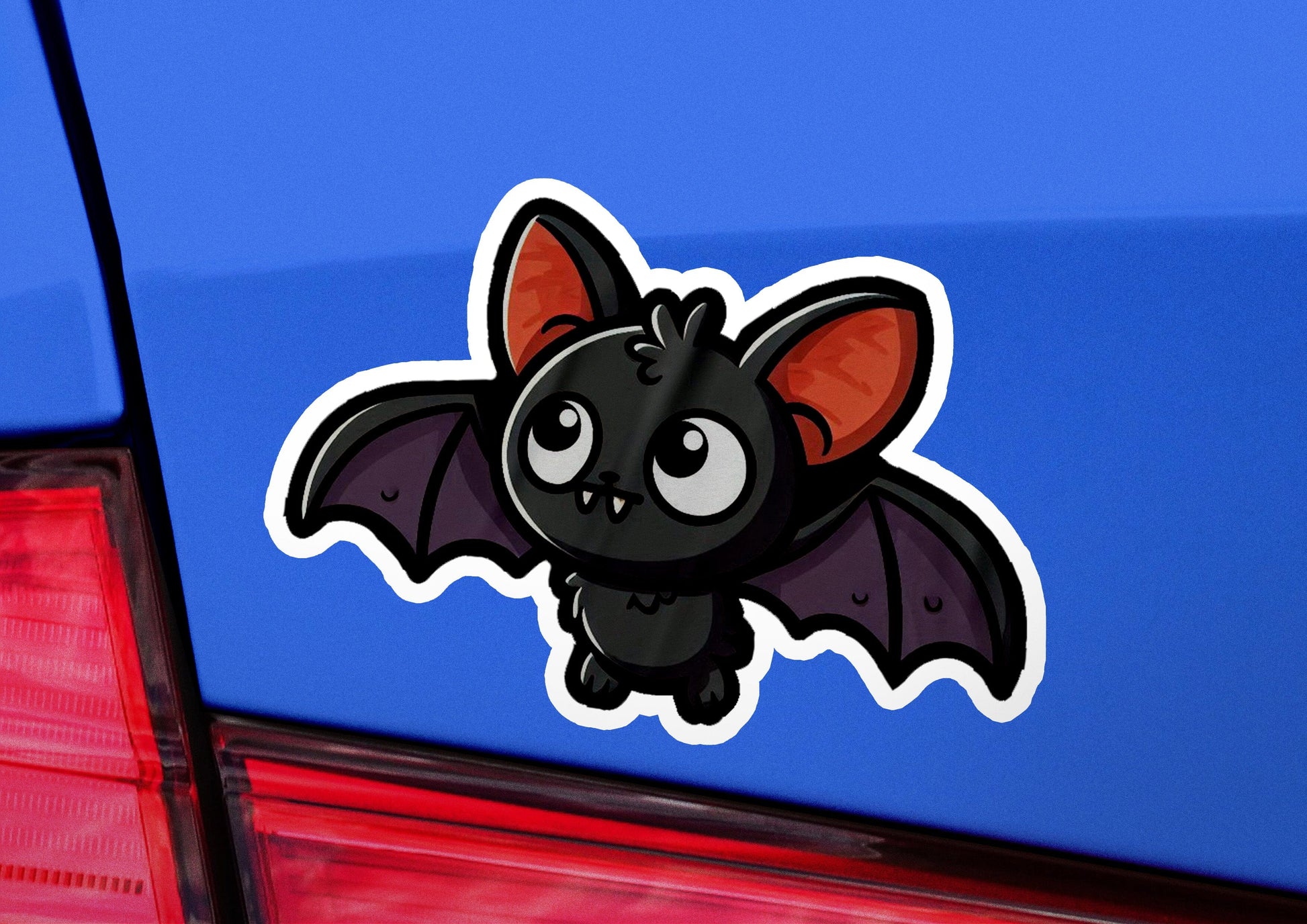 a sticker of a bat on the back of a car