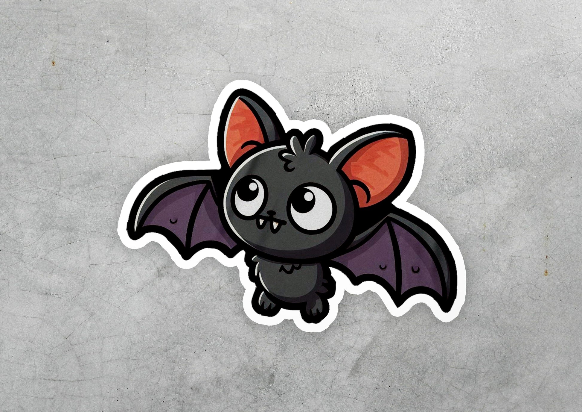 a sticker of a bat with big eyes