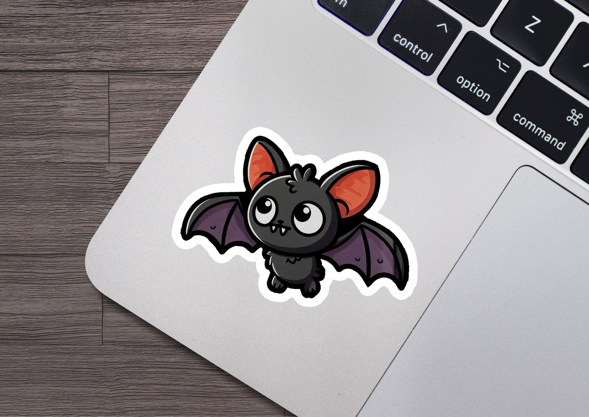 a sticker of a bat on a laptop