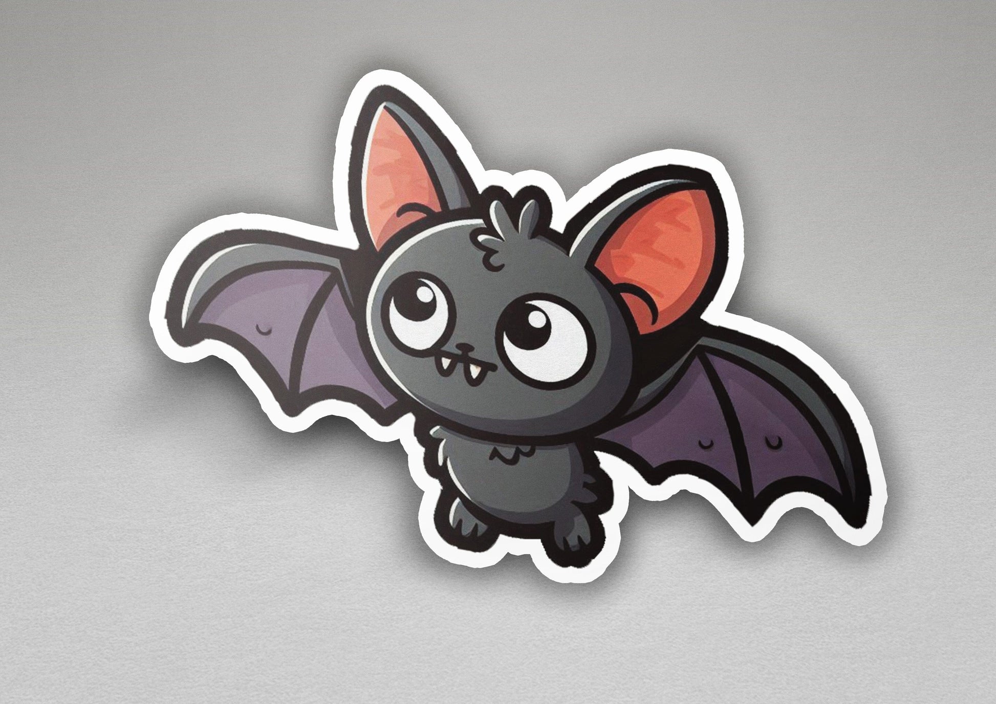 a sticker of a bat with big eyes