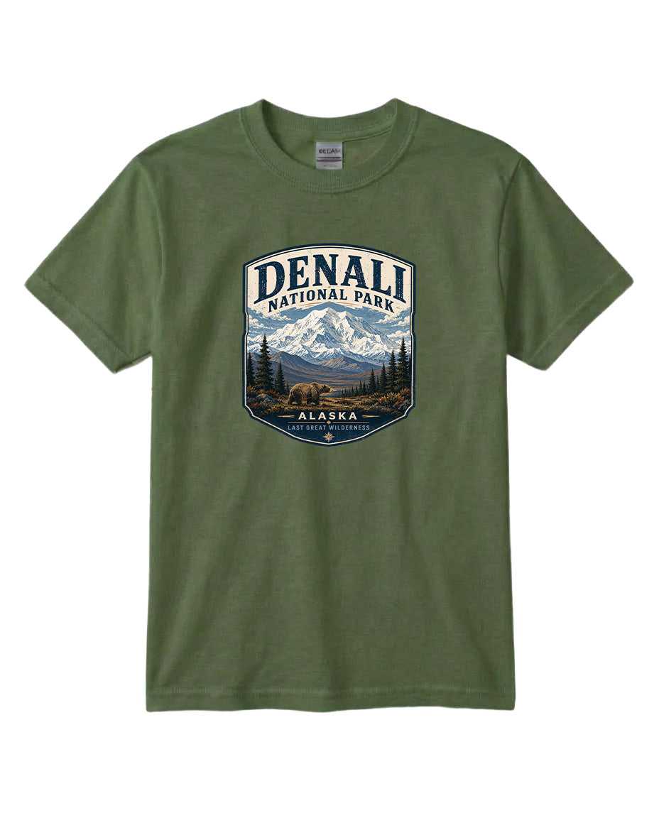 A green t-shirt with a graphic design depicting a mountain landscape with a bear and the text "DENALI NATIONAL PARK ALASKA LAST GREAT WILDERNESS".