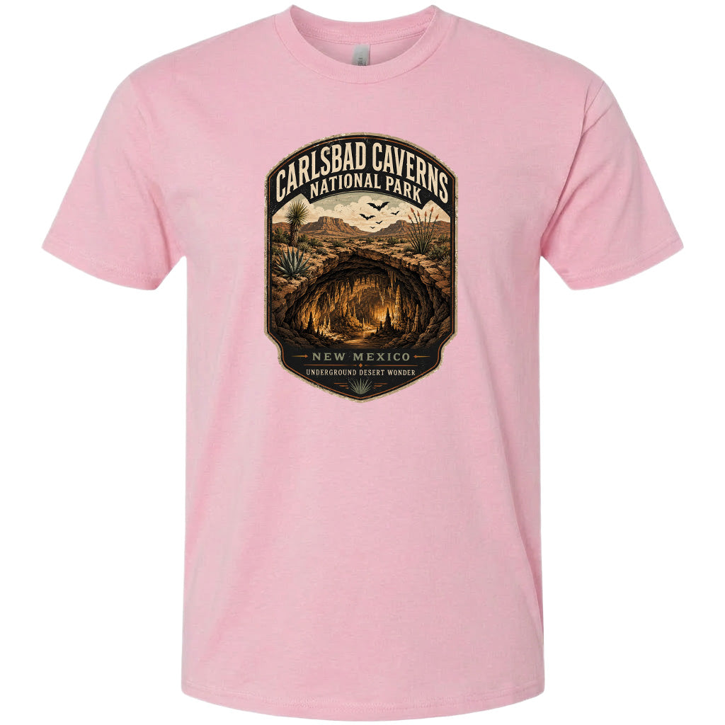A pink t-shirt with a graphic design depicting the Carlsbad Caves National Park in New Mexico.