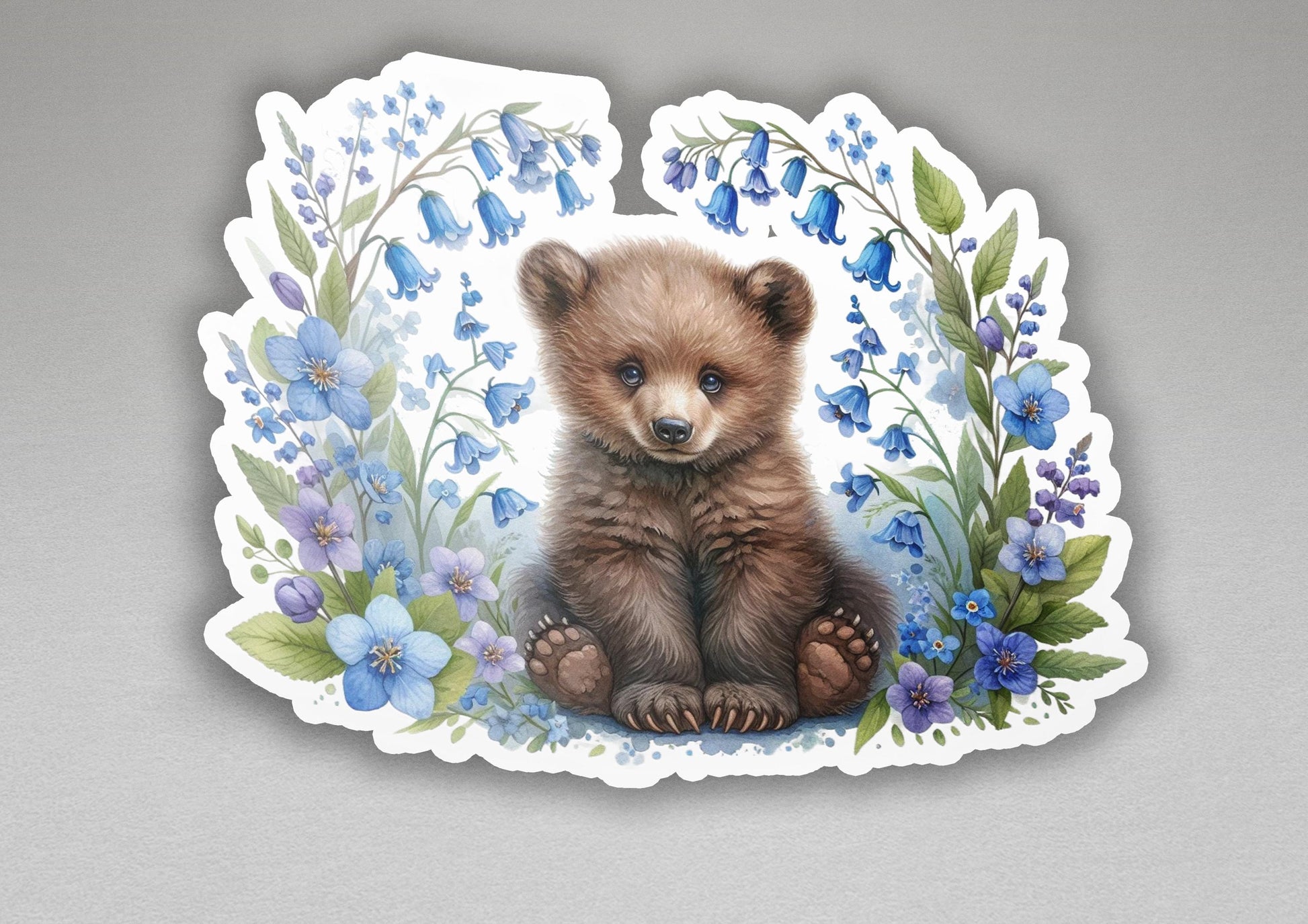 a sticker of a brown bear surrounded by blue flowers