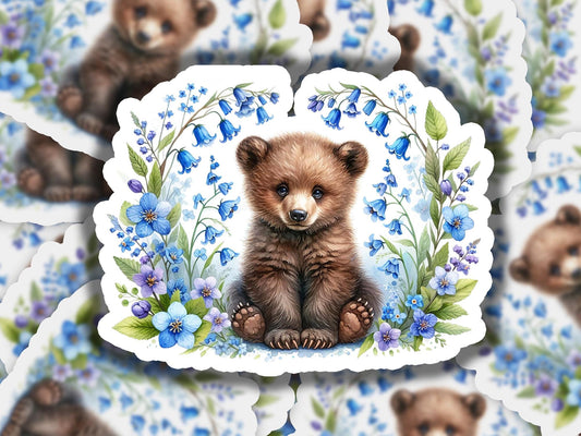 a picture of a brown bear surrounded by blue flowers
