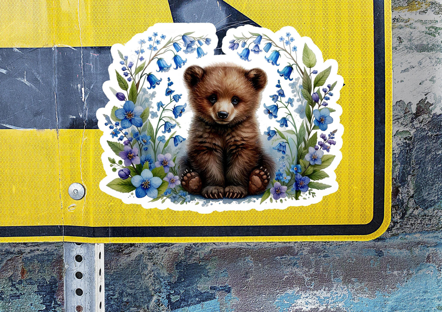 a sticker of a brown bear sitting on top of a sign