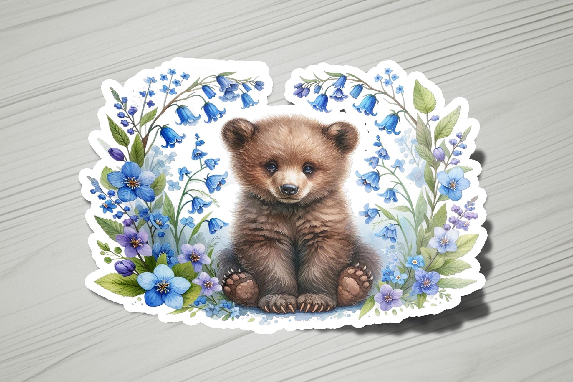 a picture of a brown bear surrounded by blue flowers