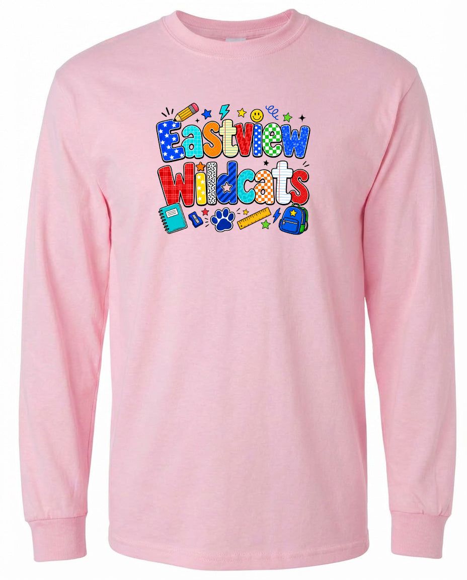 A pink long-sleeved shirt with a colorful graphic design featuring the text "Eastview Wildcats" and various school-related icons such as a backpack, pencil, and book.