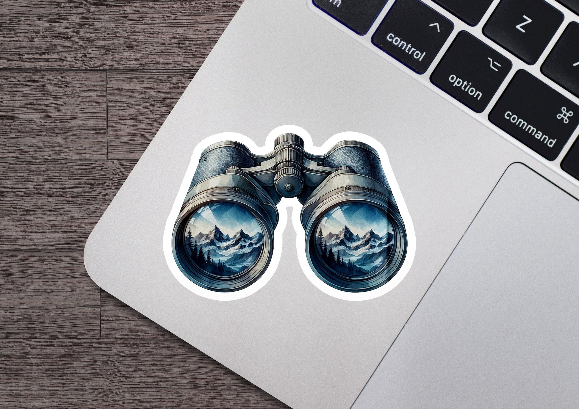 a laptop with a sticker of a pair of binoculars