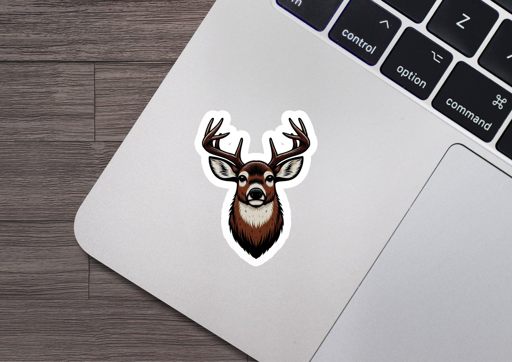 a sticker of a deer's head on a laptop