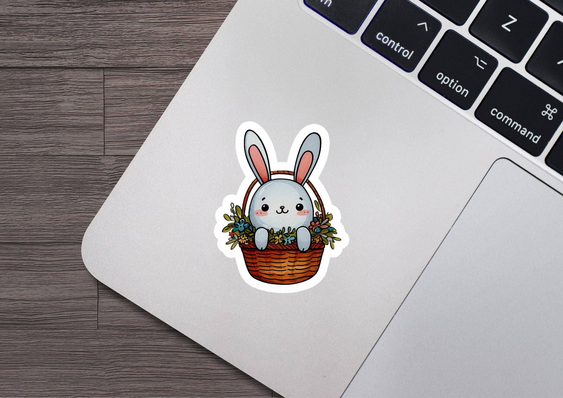 a laptop with a sticker of a bunny in a basket