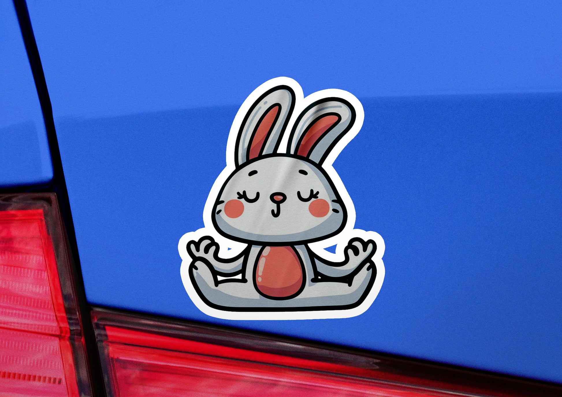 a sticker of a rabbit sitting on the back of a car