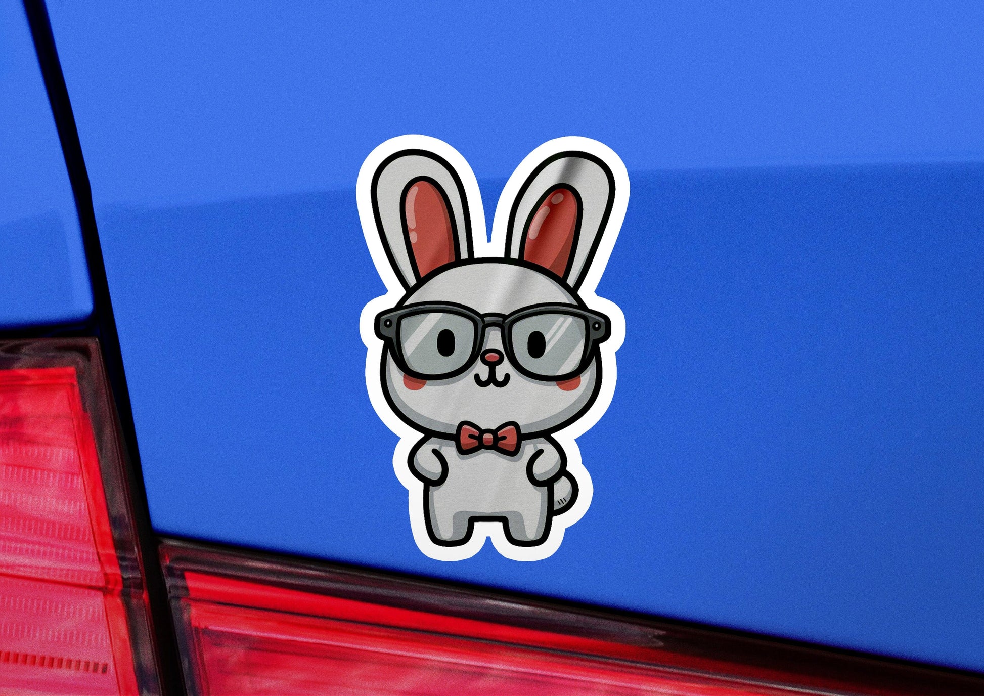 a sticker of a rabbit wearing glasses and a bow tie