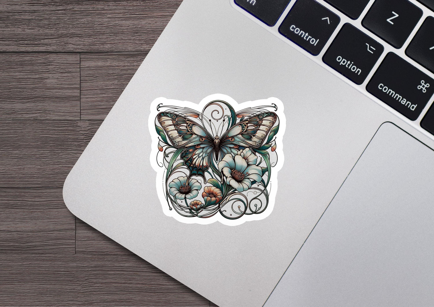 a laptop with a sticker of a butterfly on it