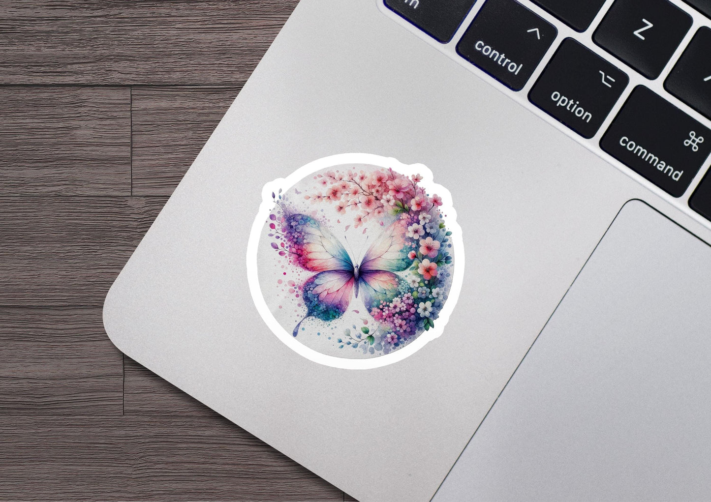 a laptop with a sticker of a butterfly on it