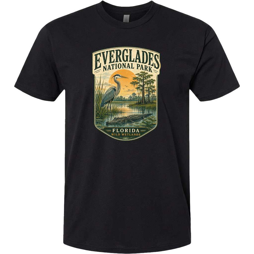 A black t-shirt with a graphic design depicting a bird standing in a marshy area with a bird in the background.