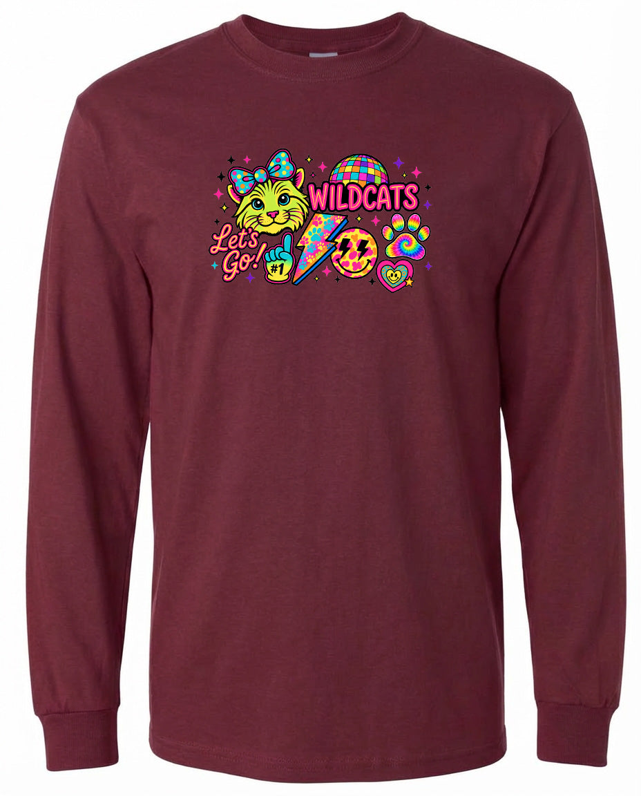 A burgundy long-sleeved t-shirt with a colorful graphic design featuring a cat, a lightning bolt, and various other elements.