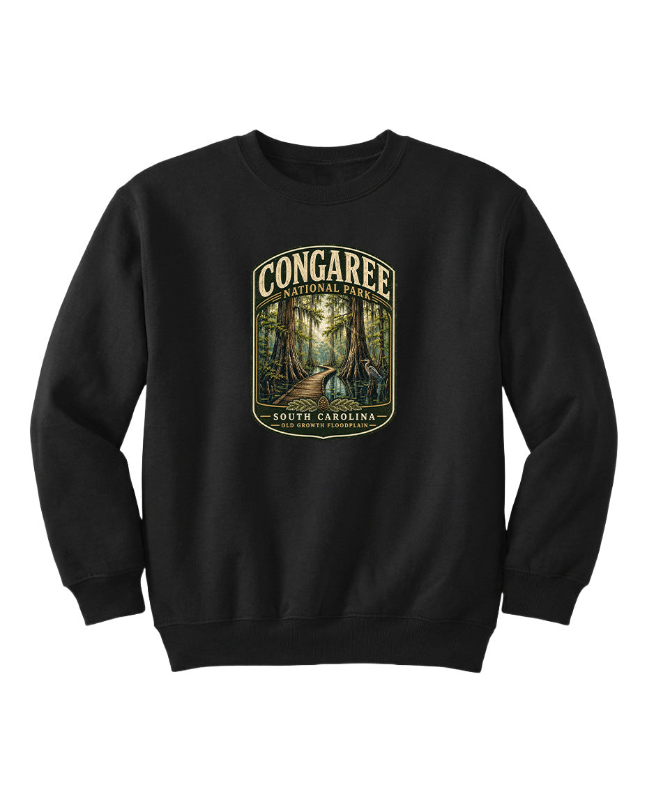A black sweatshirt with a graphic design depicting a forest scene, featuring the text "CONGAREE NATIONAL PARK SOUTH CAROLINA" prominently displayed.