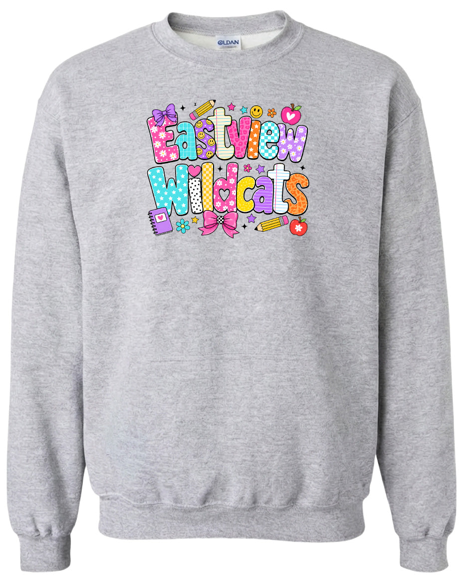 A gray sweatshirt with a colorful graphic design featuring the text "Eastview Wildcats" and various school-related icons such as pencils, apples, and books.