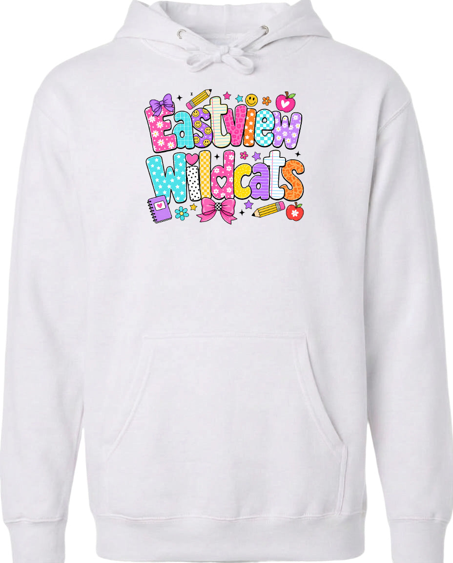 A white hoodie with a colorful graphic design featuring the text "Eastview Wildcats" and various decorative elements such as stars, hearts, and pencils.