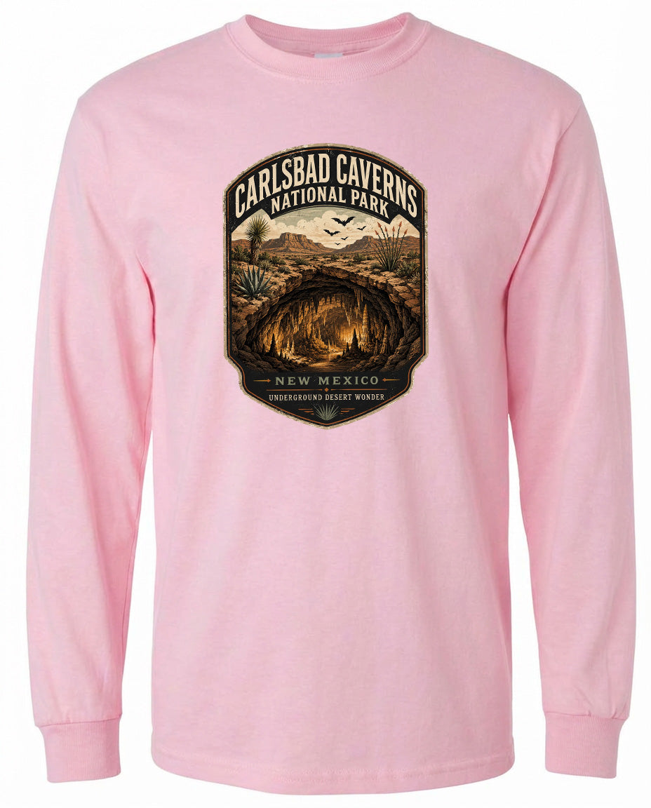 A pink long-sleeved t-shirt with a graphic design depicting the Carlsbad Caverns National Park in New Mexico.