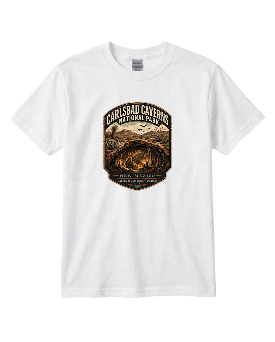 A white t-shirt with a graphic design featuring a desert landscape with a cave and mountains in the background.