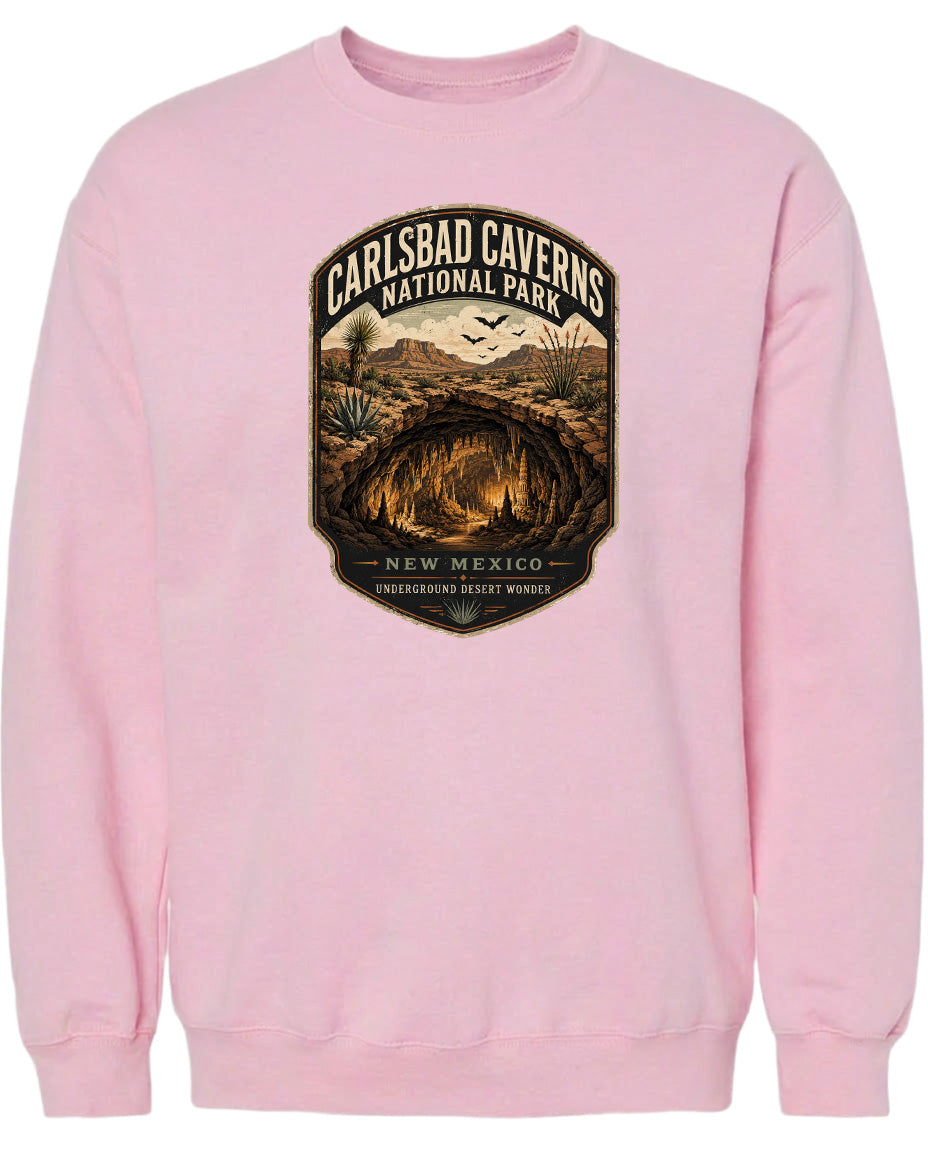 A pink sweatshirt with a graphic design depicting the Carlsbad Caverns National Park in New Mexico.