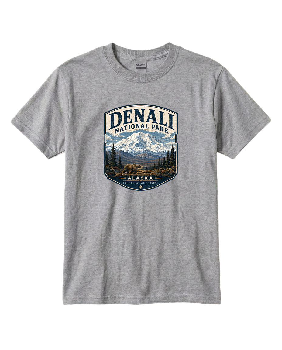 A gray t-shirt with a graphic design featuring a mountain landscape and the text "DENALI NATIONAL PARK ALASKA LAST GREAT WILDERNESS".