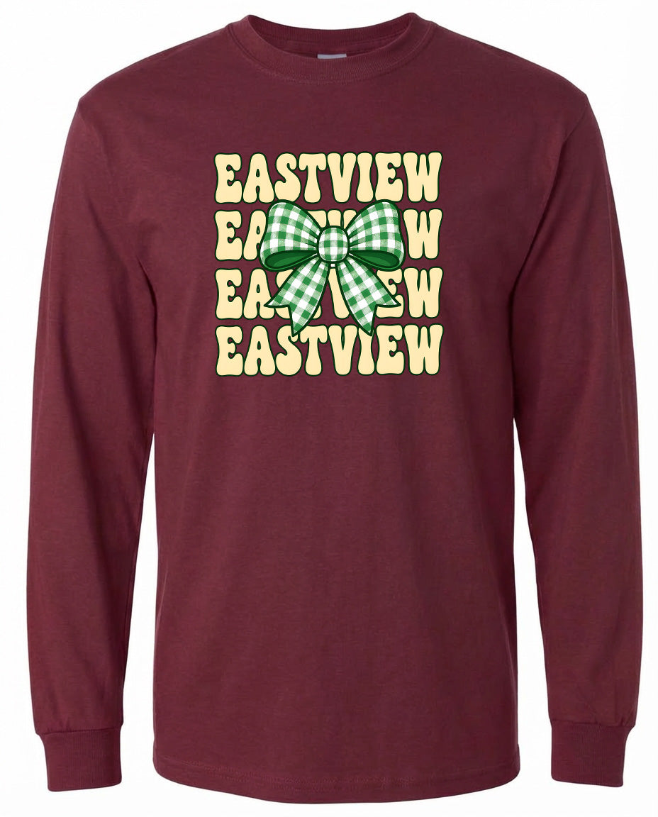 A burgundy long-sleeved t-shirt with a graphic design featuring a green and white checkered bow and the text "EASTVIEW" repeated in a vertical pattern.