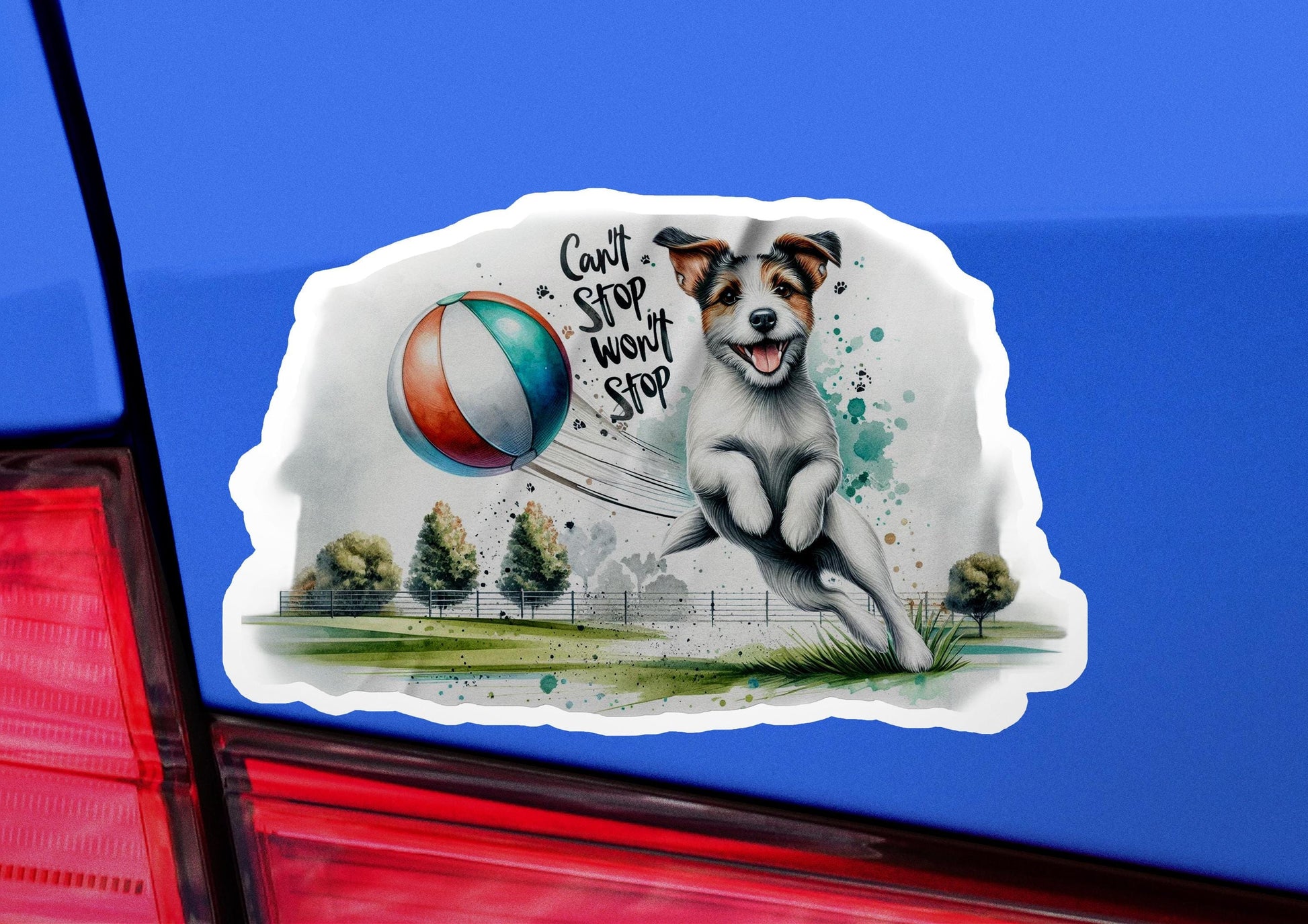 a sticker of a dog catching a ball on the back of a car