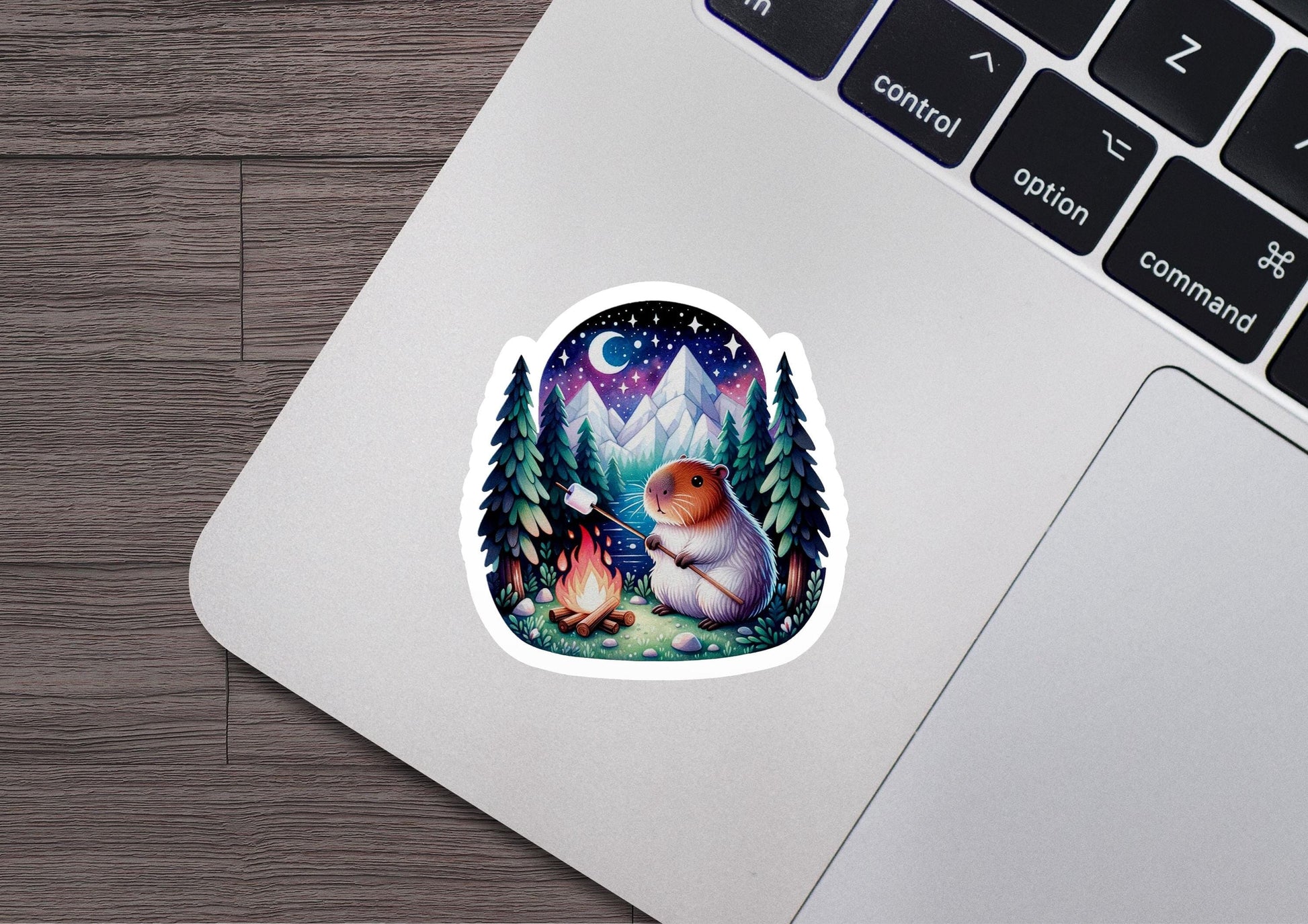 a laptop with a sticker of a bear in the woods