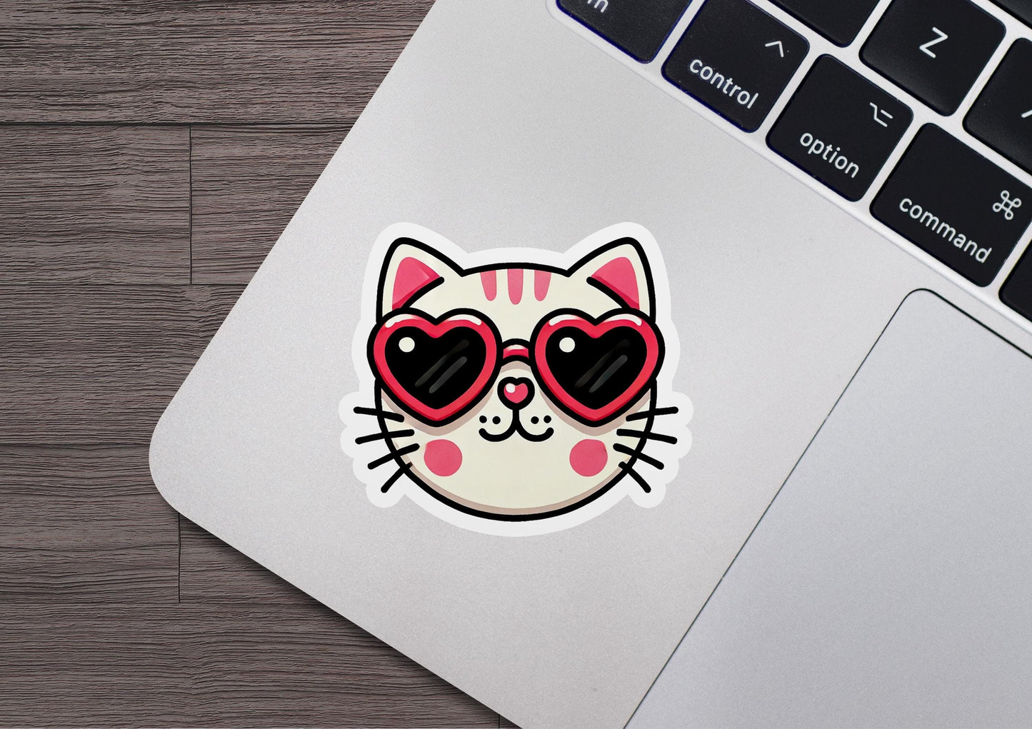 a laptop with a sticker of a cat wearing sunglasses