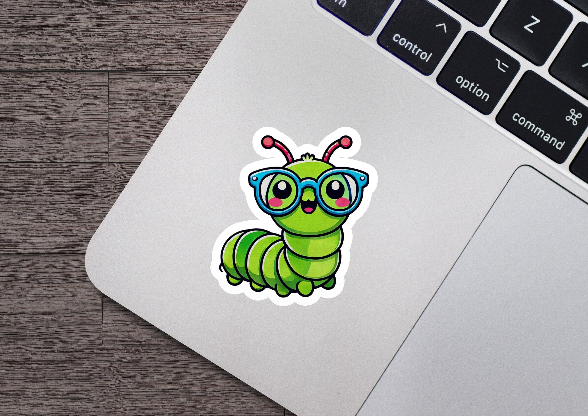 a sticker of a green caterpillar wearing glasses