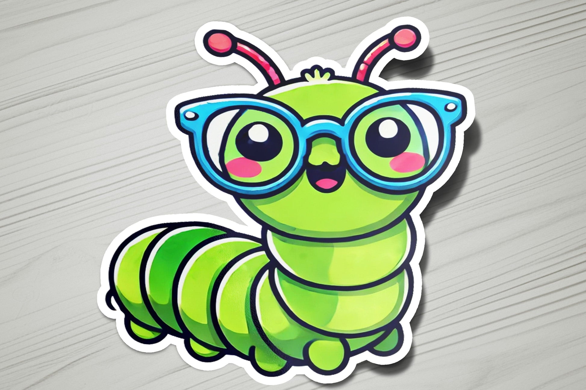 a sticker of a green caterpillar wearing glasses